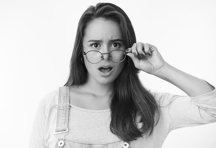woman dropping jaw gasping displeased frowning taking off glasses