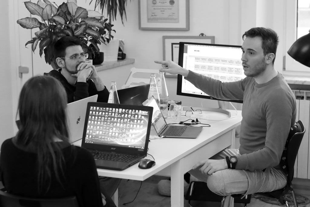 Group of professionals in an meeting with laptops with 15 years of experience in autism-related interventions.